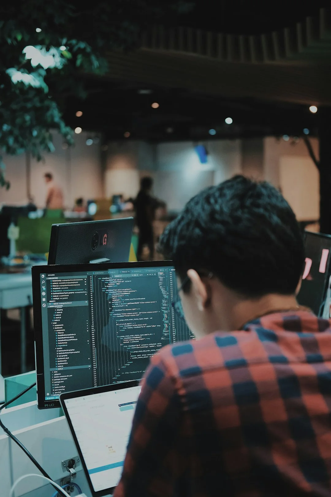 who-we-are Two monitors on a desk, displaying web design in a modern office setting.